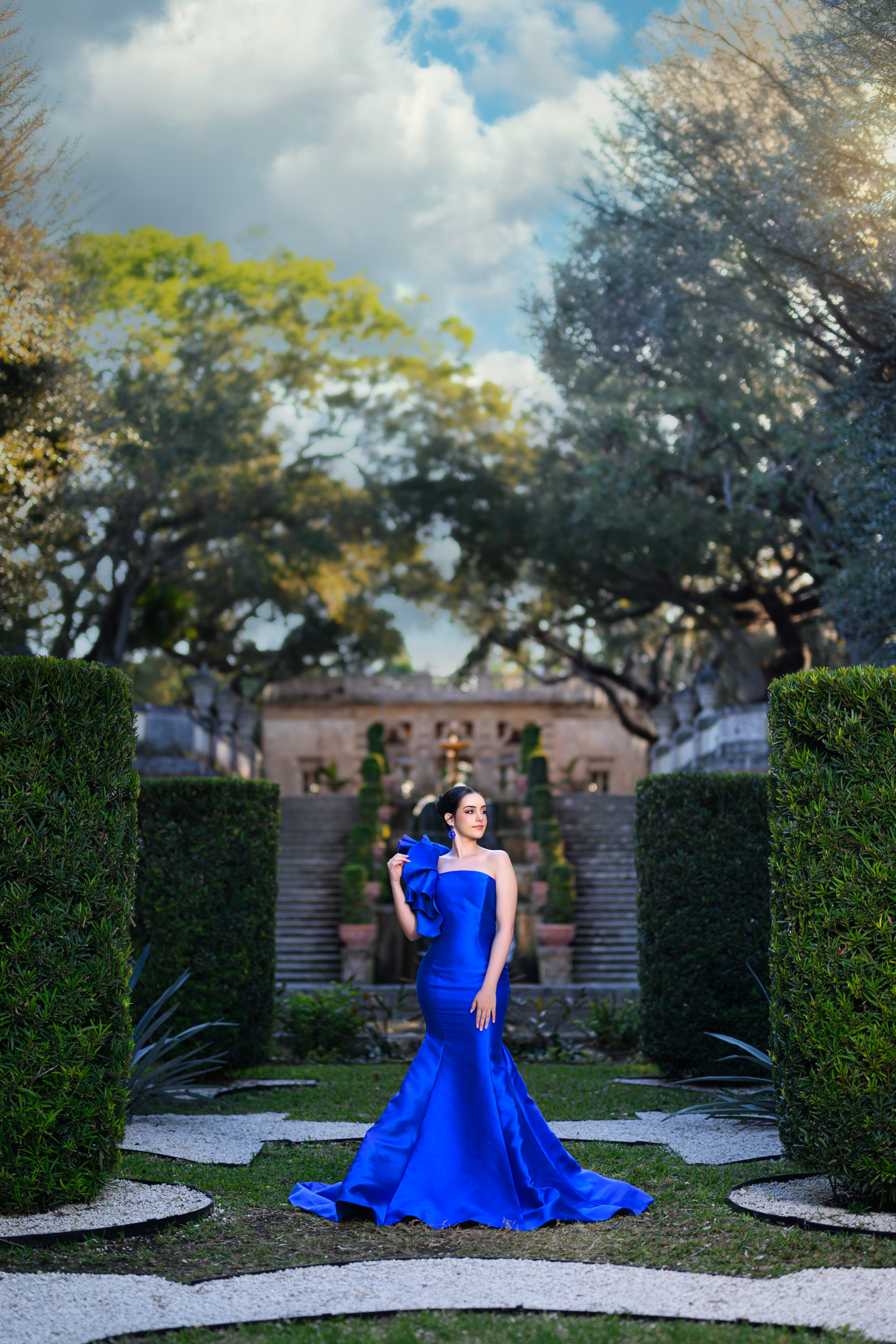 Model wearing a sculpted blue Aqua Luna gala gown